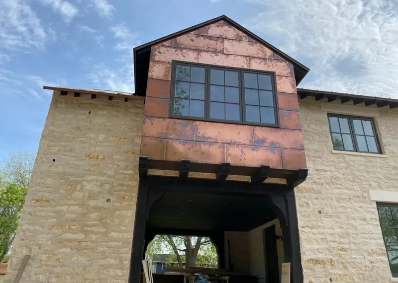 Copper metal panel facade on a stone building for Metal Roof Coating in Vidor