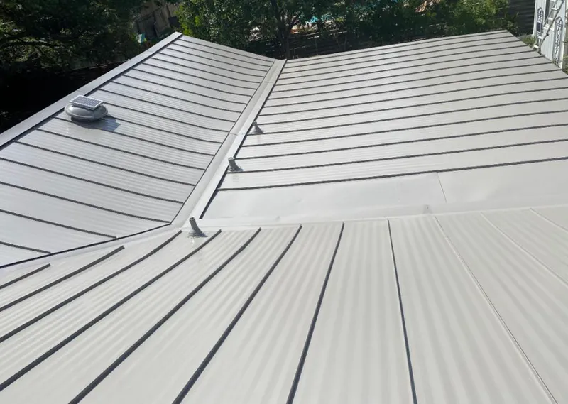 Solar attic fan installed on a metal roof for Roof Ventilation in Vidor